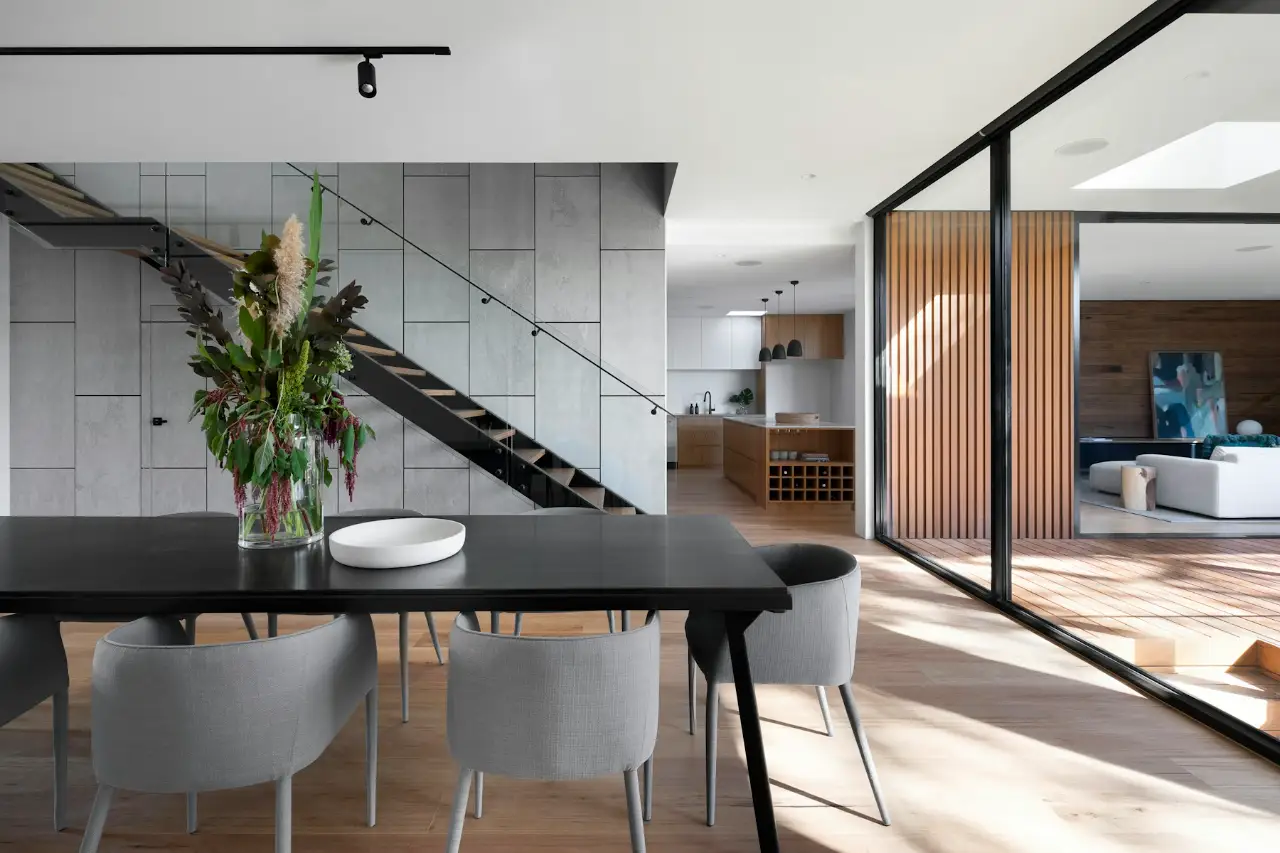 Dining room with a sculptural staircase